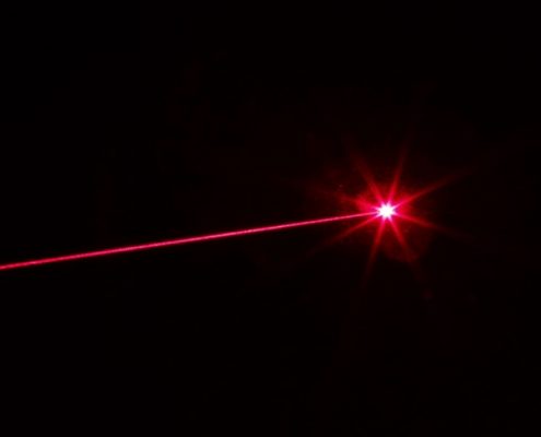 Red laser beam on black background