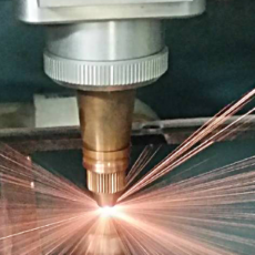 image of a laser beam cutting a part shape made of metal for the electronics industry.